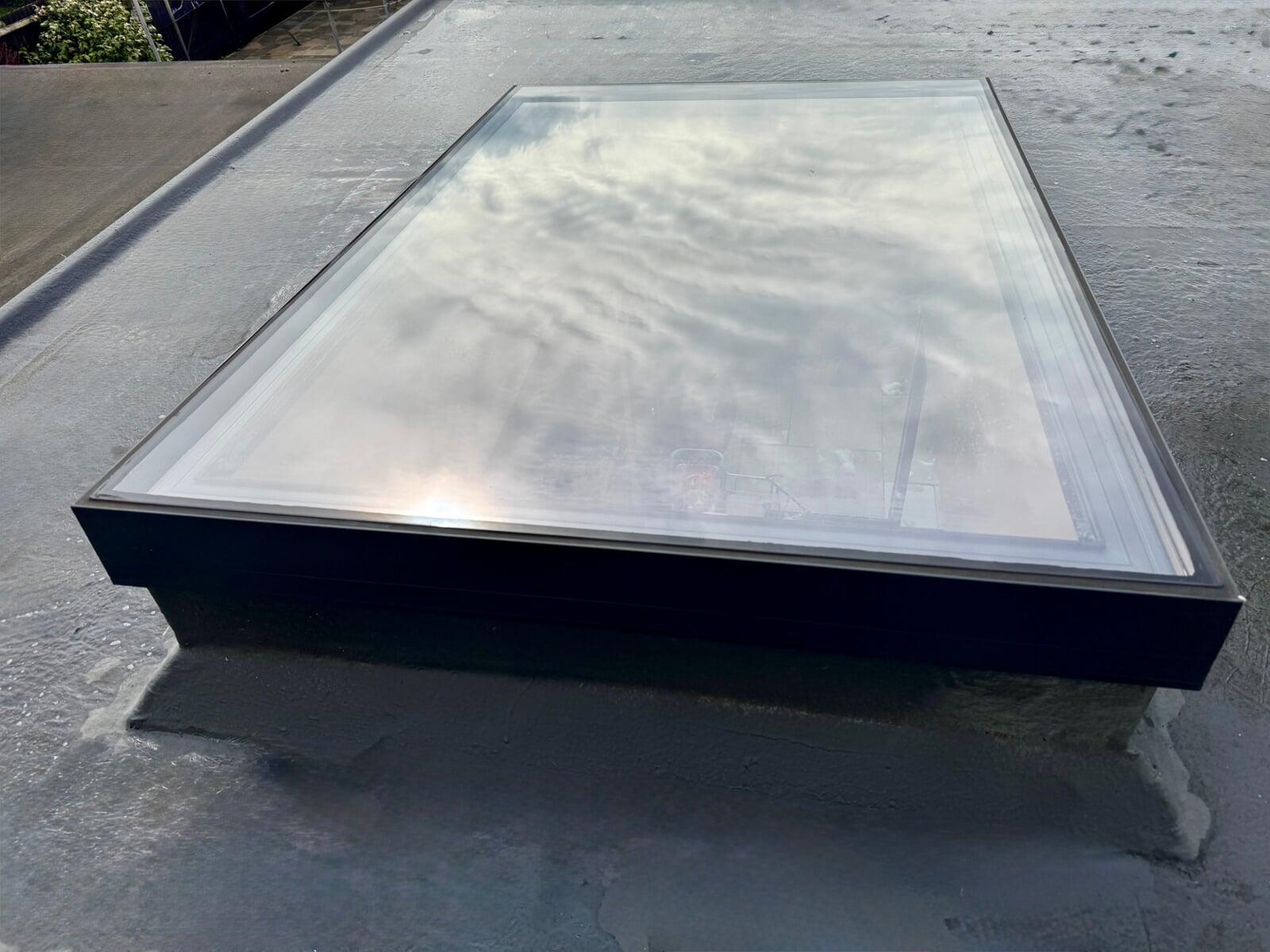 Flat glass rooflight installed on flat roof with slim aluminium frame