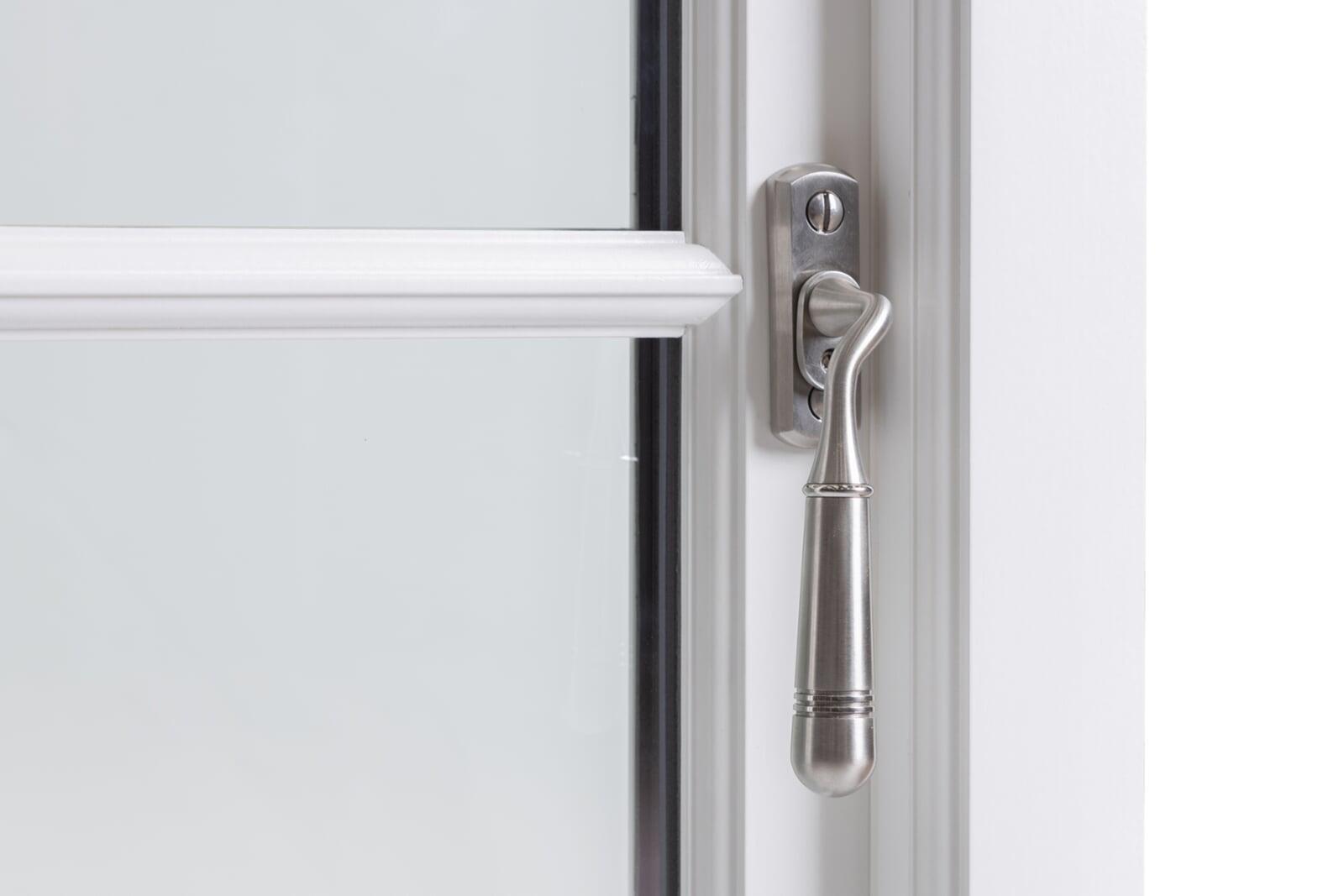 Traditional chrome handle on painted timber sash window