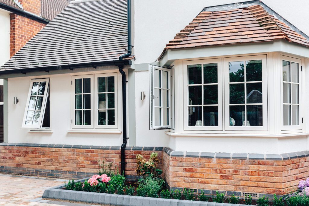 Residence 9 flush sash windows installed on a traditional British home with bay window design