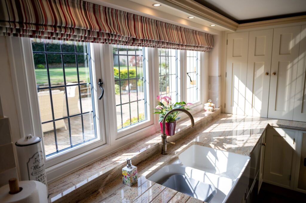 Traditional flush sash kitchen windows providing natural light in a classic country style interior