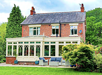Traditional home with painted timber windows and conservatory